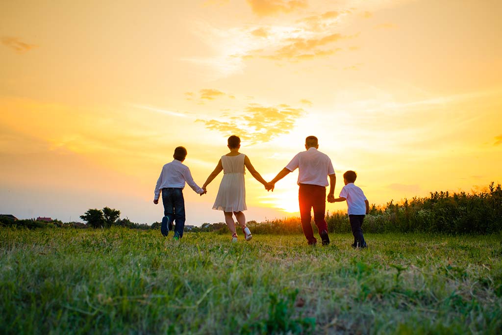 emotional healing - family in field at sunrise